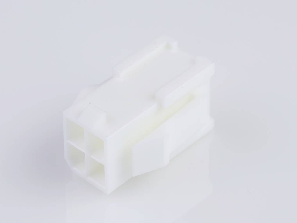 A white, rectangular plastic plug with multiple holes, lying on a smooth surface, neutral background colour.