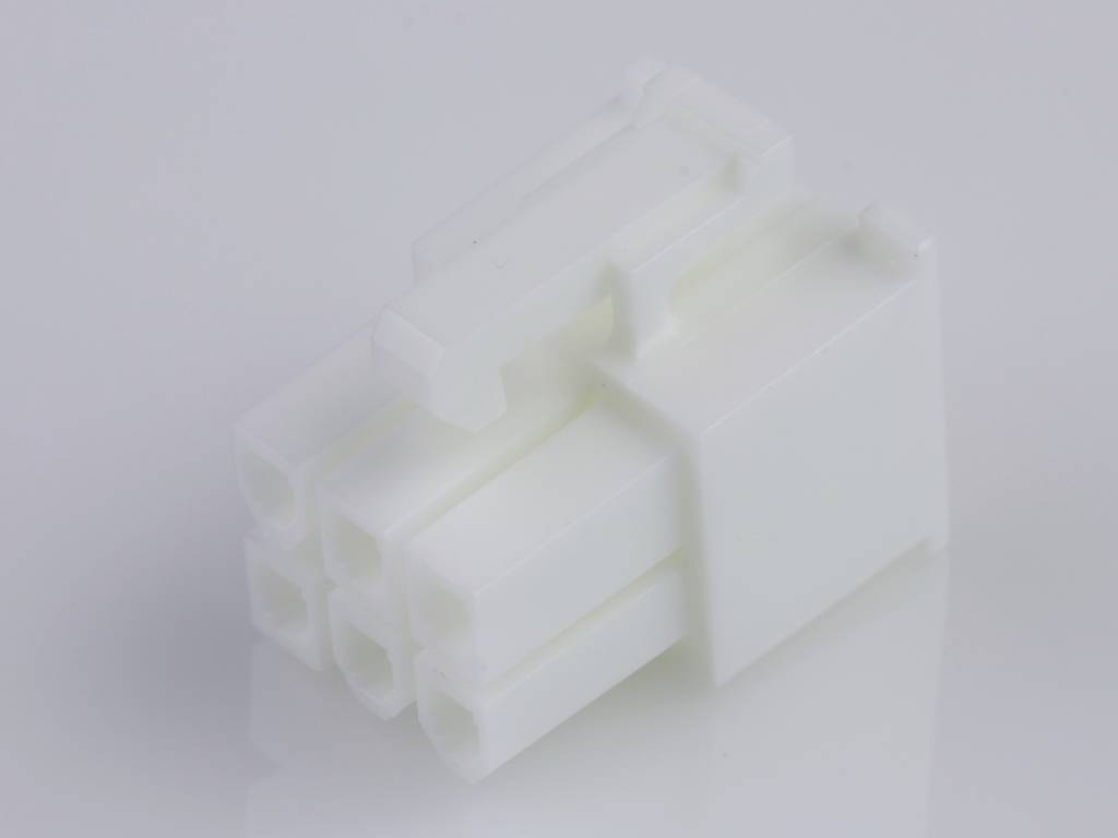 A white, six-pin plastic plug lying on a smooth surface, used for electronic device connections.