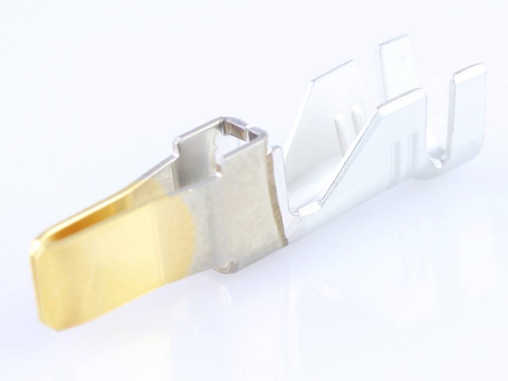A single metal contact with a gold-coloured tip, presumably for electrical connections. Rests on a light-coloured surface.