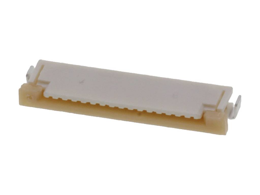 A white, rectangular electronic component connector, flat and with multiple pins, lying on a light surface.