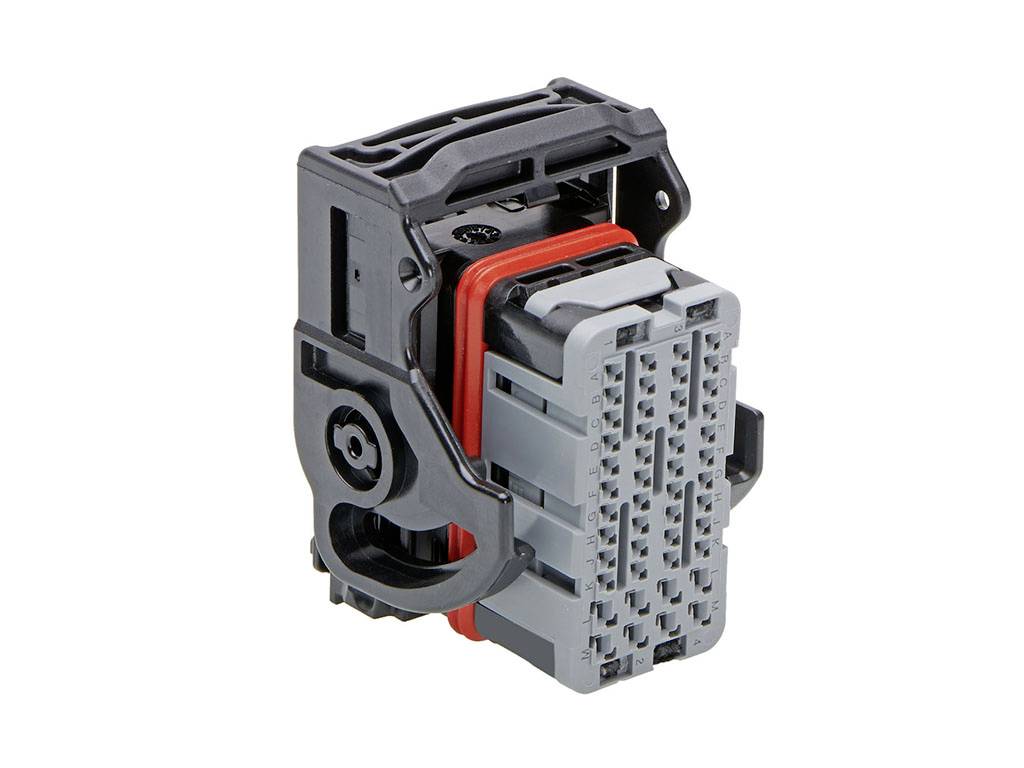 A grey and black electrical connector with multiple ports and a red sealing ring.