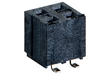 Black, cuboid electrical connector with metal terminals on the underside.