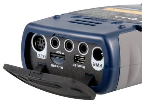 Close-up of a handheld electronic device with a front port panel, including round jacks, a Mini-USB port, and a labeled power input.