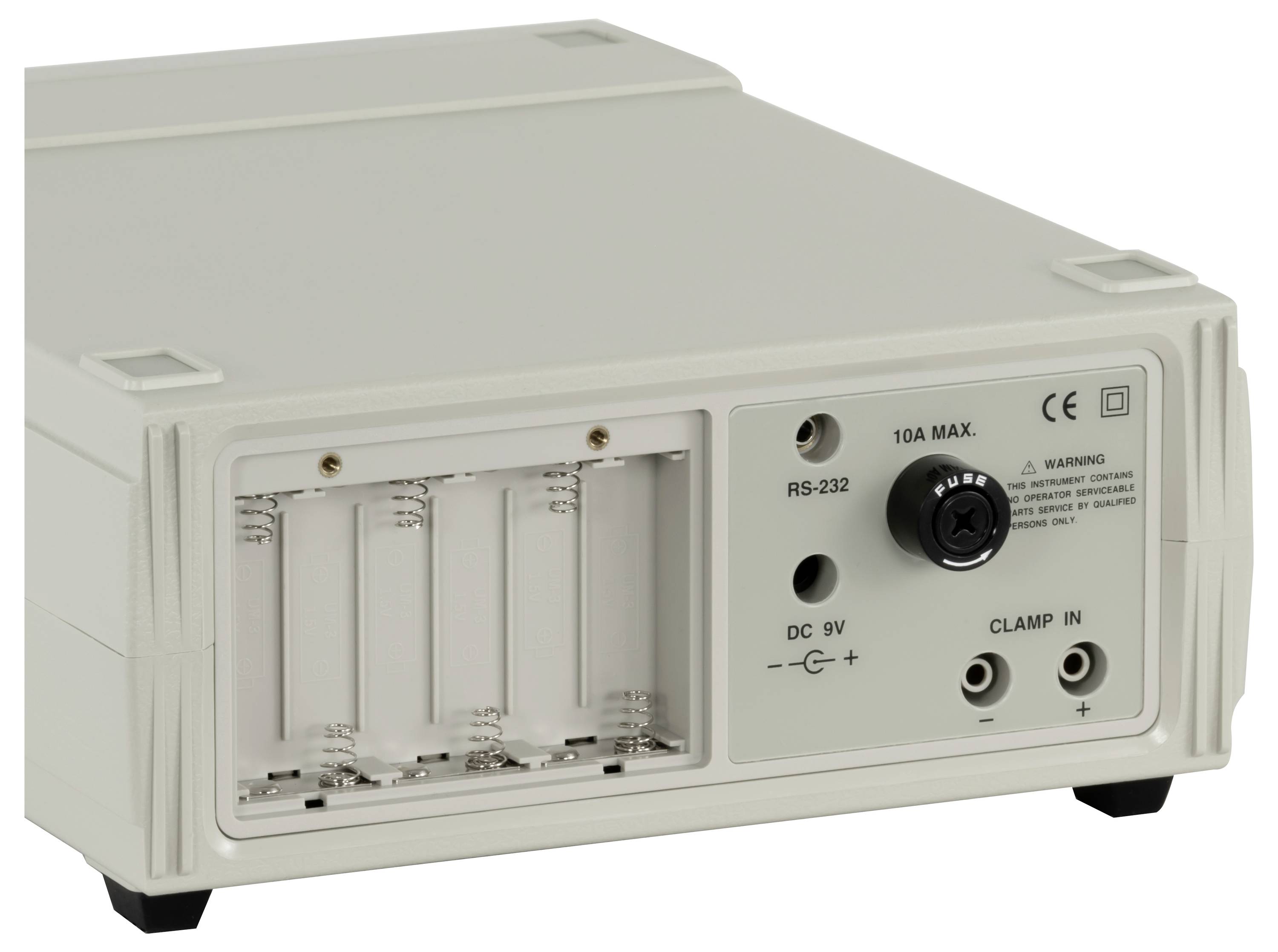 Small gray electronic device with battery compartment, RS-232 port, 9V DC input, and clamp-in connectors on the front panel.