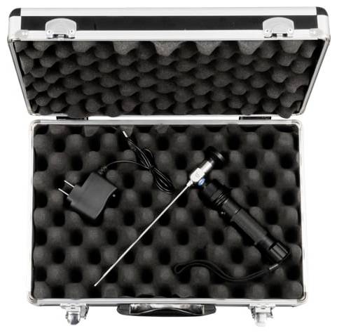 Open silver case with foam holding a wired handheld probe or tool and a power adapter.