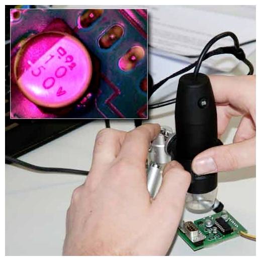 Hands using a microscope to inspect a small electronic circuit board, with an inset close-up of a pink capacitor marked '50V 220F'.