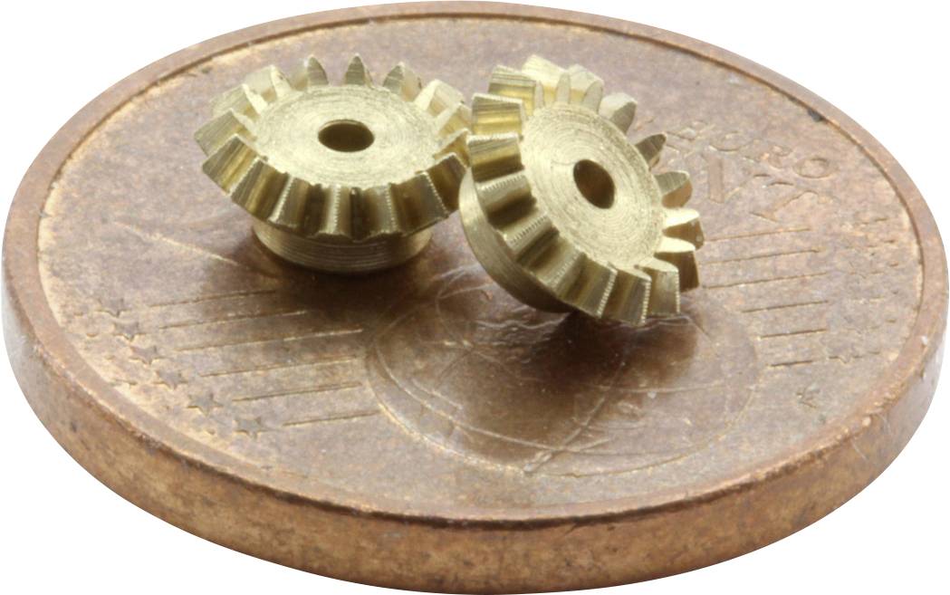 Two small brass cogwheels lie on a euro cent coin, showing the size comparison between the cogwheels and the coin.