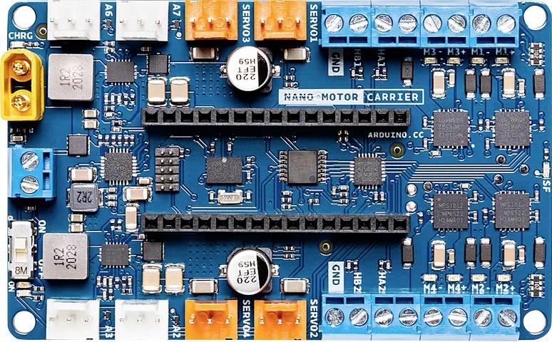 Electronic circuit board with various connection ports and chips on a blue surface. The label 'NANO-MOTOR CARRIER' is visible.