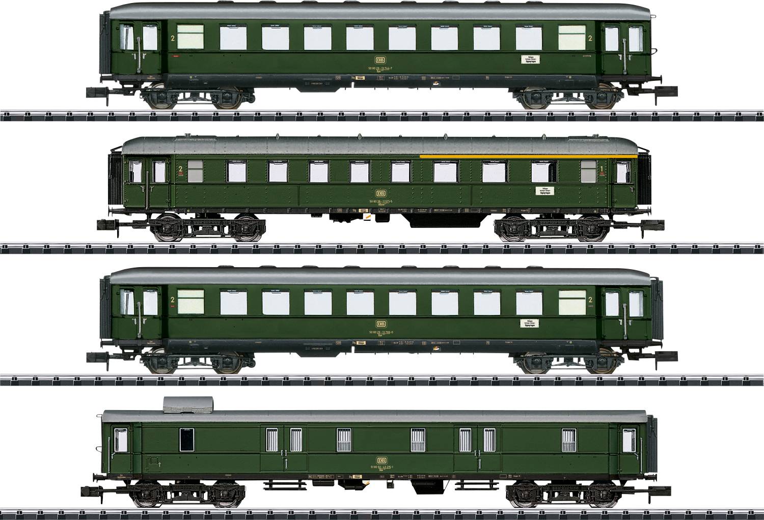 Four green railway carriages in a row on a track. Variations in window and door configurations. Nostalgic design from the classic railway era.