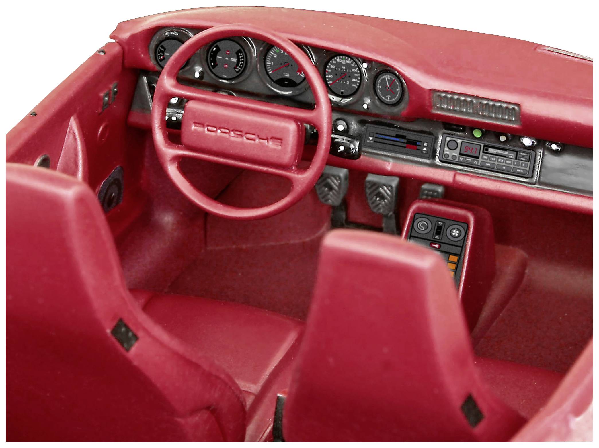 Red interior of a classic sports car with steering wheel, dashboard and vehicle seats. Cockpit shows many indicators.