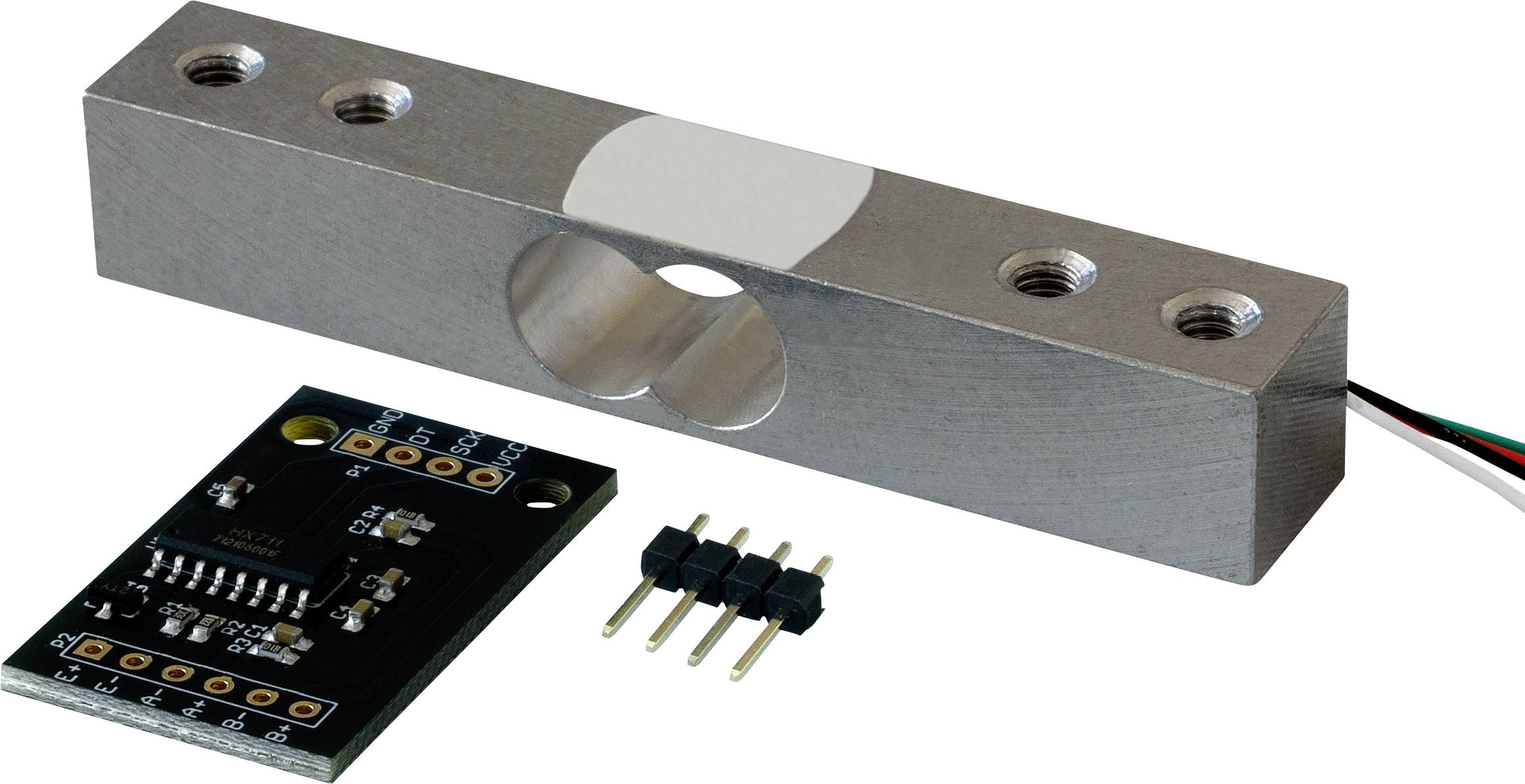 A rectangular metal load sensor with a hole, alongside a circuit board with connectors. Used for weight measurement.