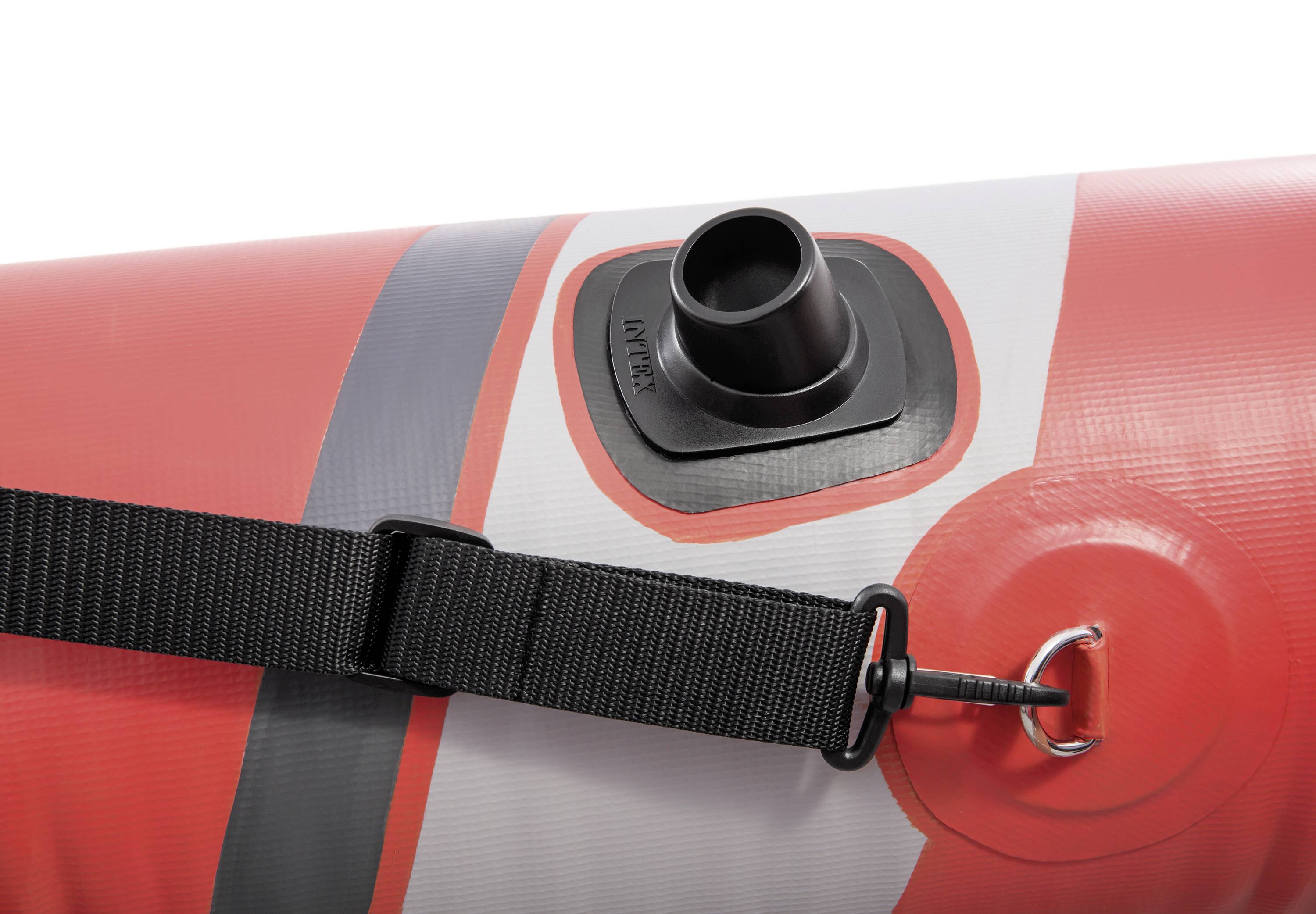 Red inflatable boat valve in close-up with black securing strap and silver D-ring on the side.