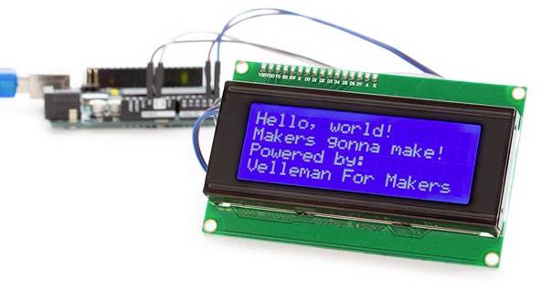 An LCD screen displays the message 'Hello, world! Makers gonna make! Powered by: Velleman For Makers'. An electronic circuit is visible in the background.