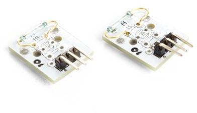 Two small electronic circuit boards with copper wire arches and pins lying side by side.