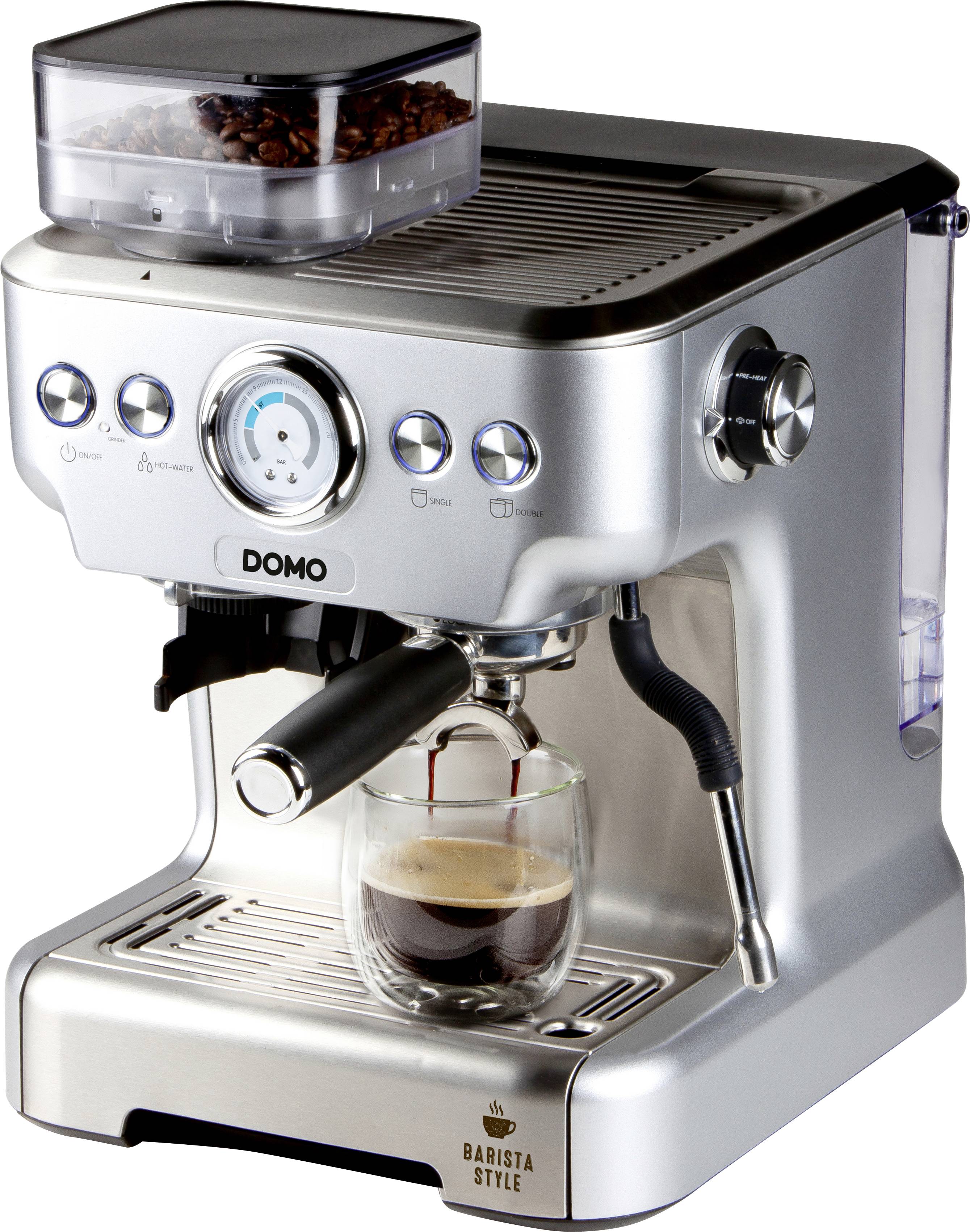 Silver espresso machine with a glass carafe underneath, coffee flowing in. Bean container on top, several switches and a pressure gauge.