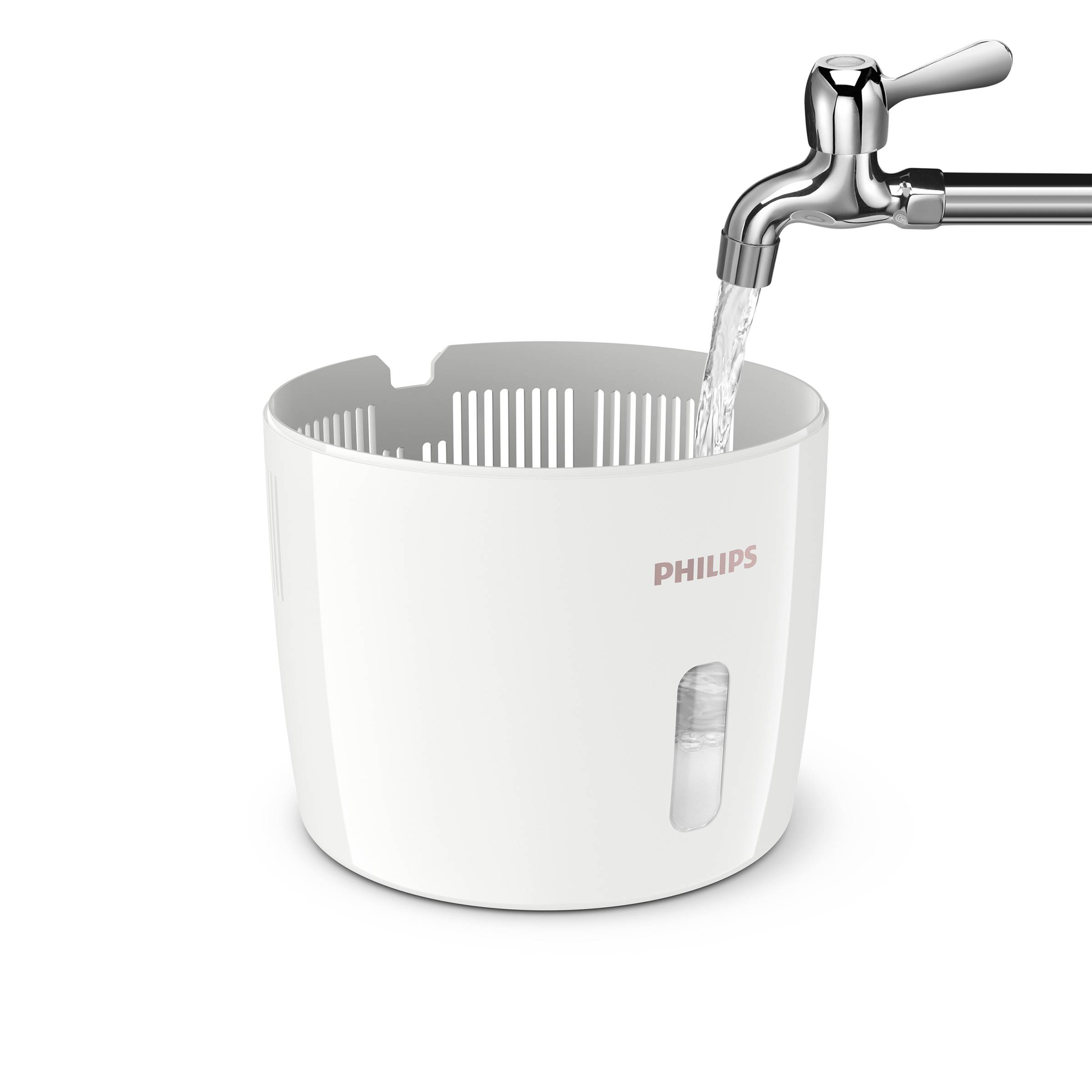 A white water filter container with a 'Philips' logo, positioned under a running tap.