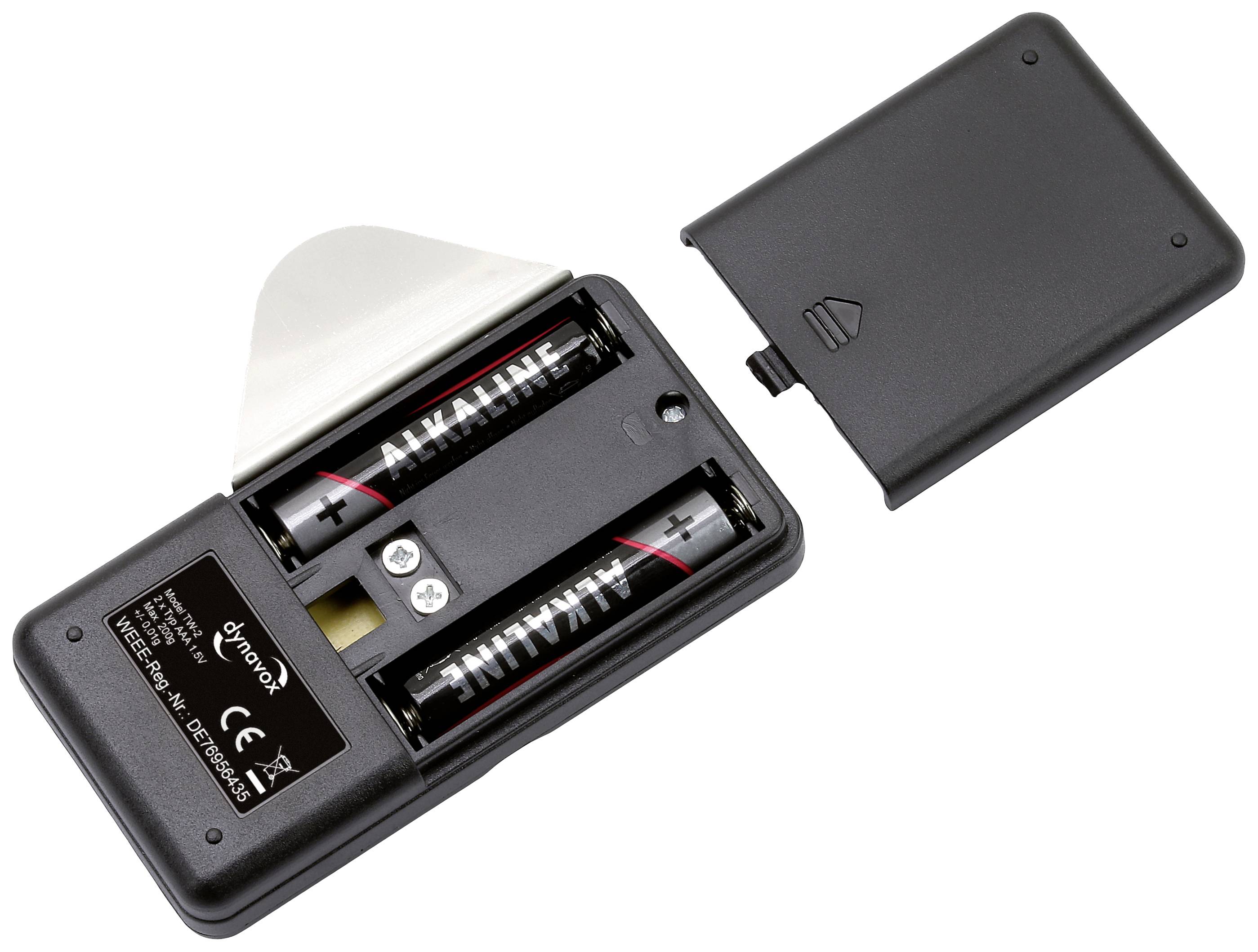 Open battery compartment of a black-grey device with two AA alkaline batteries inserted and battery compartment cover removed.