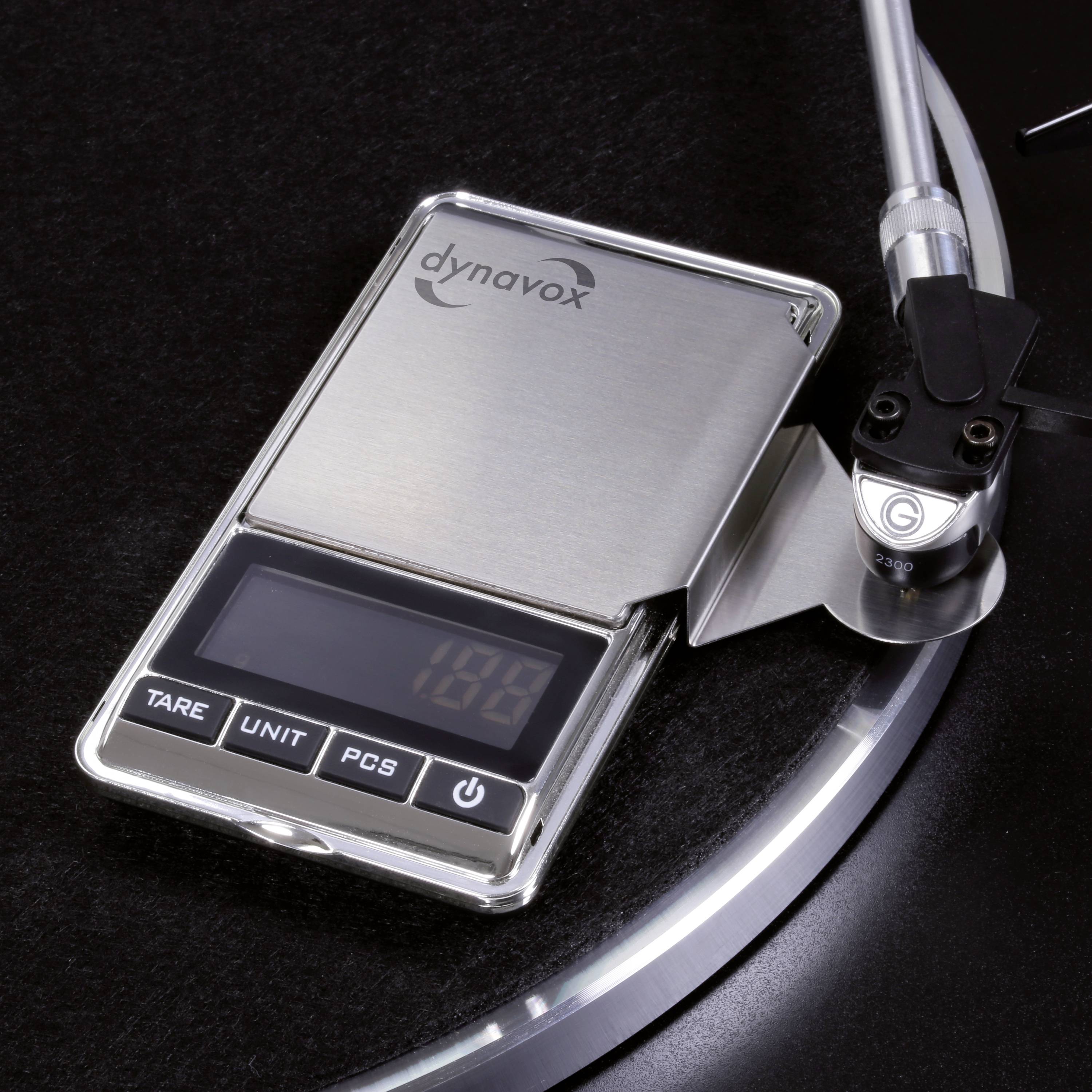 Digital precision balance positioned on a turntable arm, showing 1.89 grams. Measuring tracking force for record stylus.