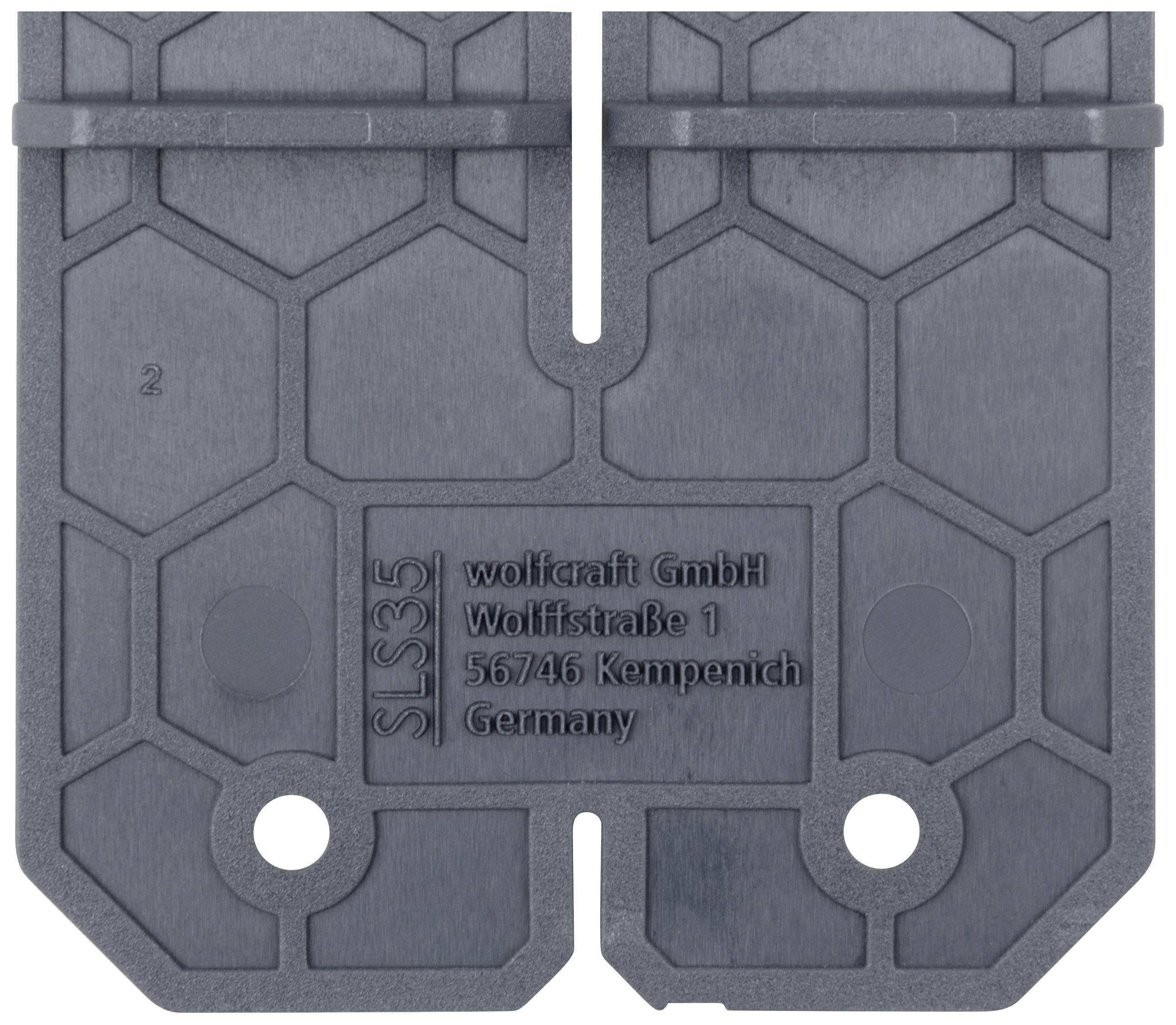 Grey plastic plate with a hexagonal pattern and inscription 'wolfcraft GmbH Wolfstraße 1 56746 Kempenich Germany'.