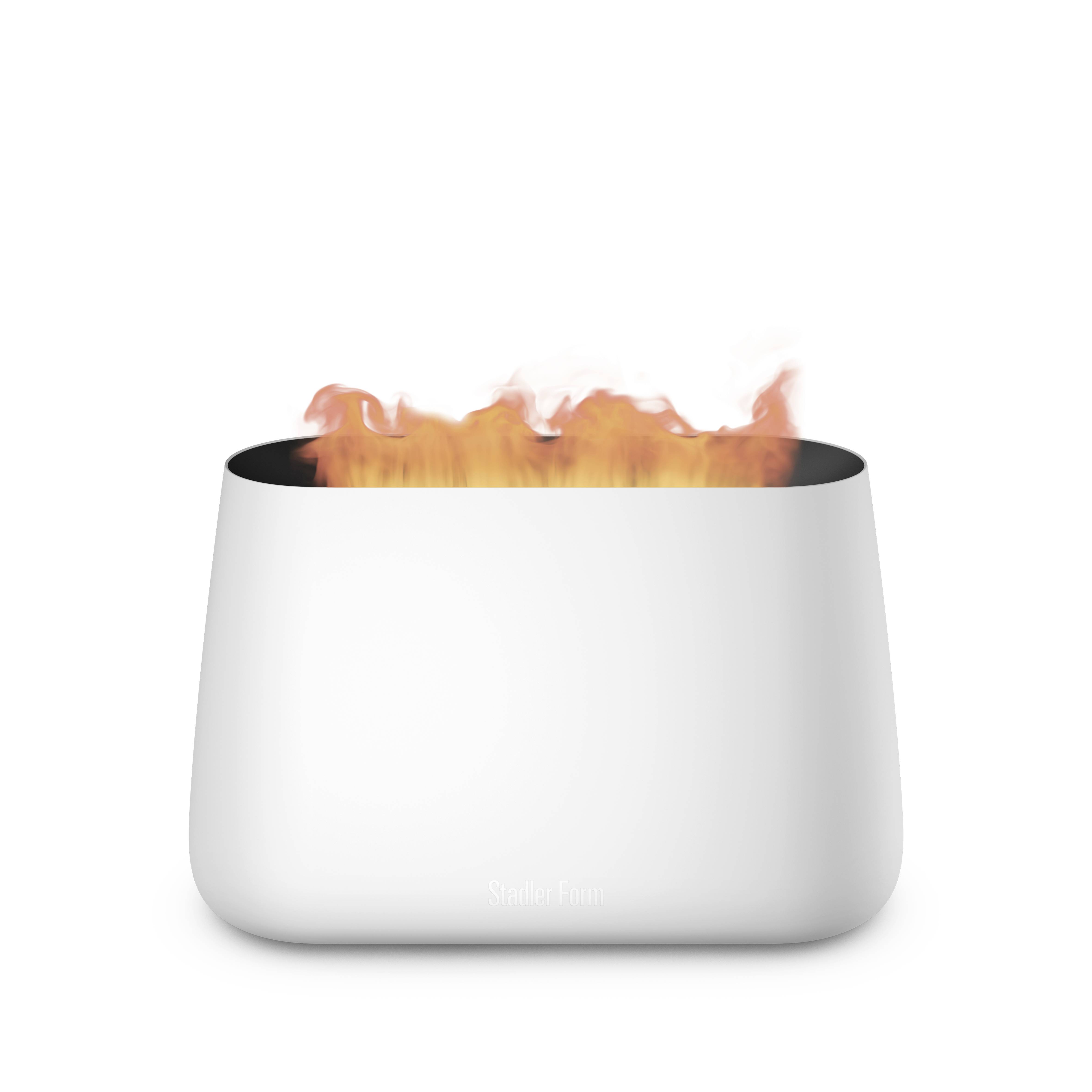 A small, modern white tabletop fireplace with visible flames. The design is simple and elegant, perfect for cosy interior spaces.