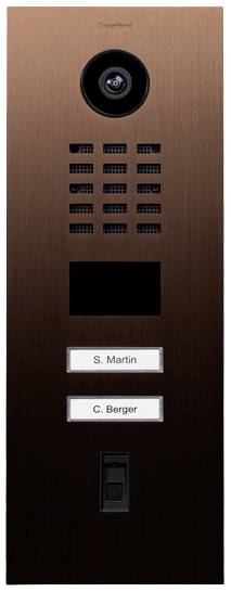 A bronze-coated door intercom with a camera and two doorbell nameplates, labelled 'S. Martin' and 'C. Berger'.
