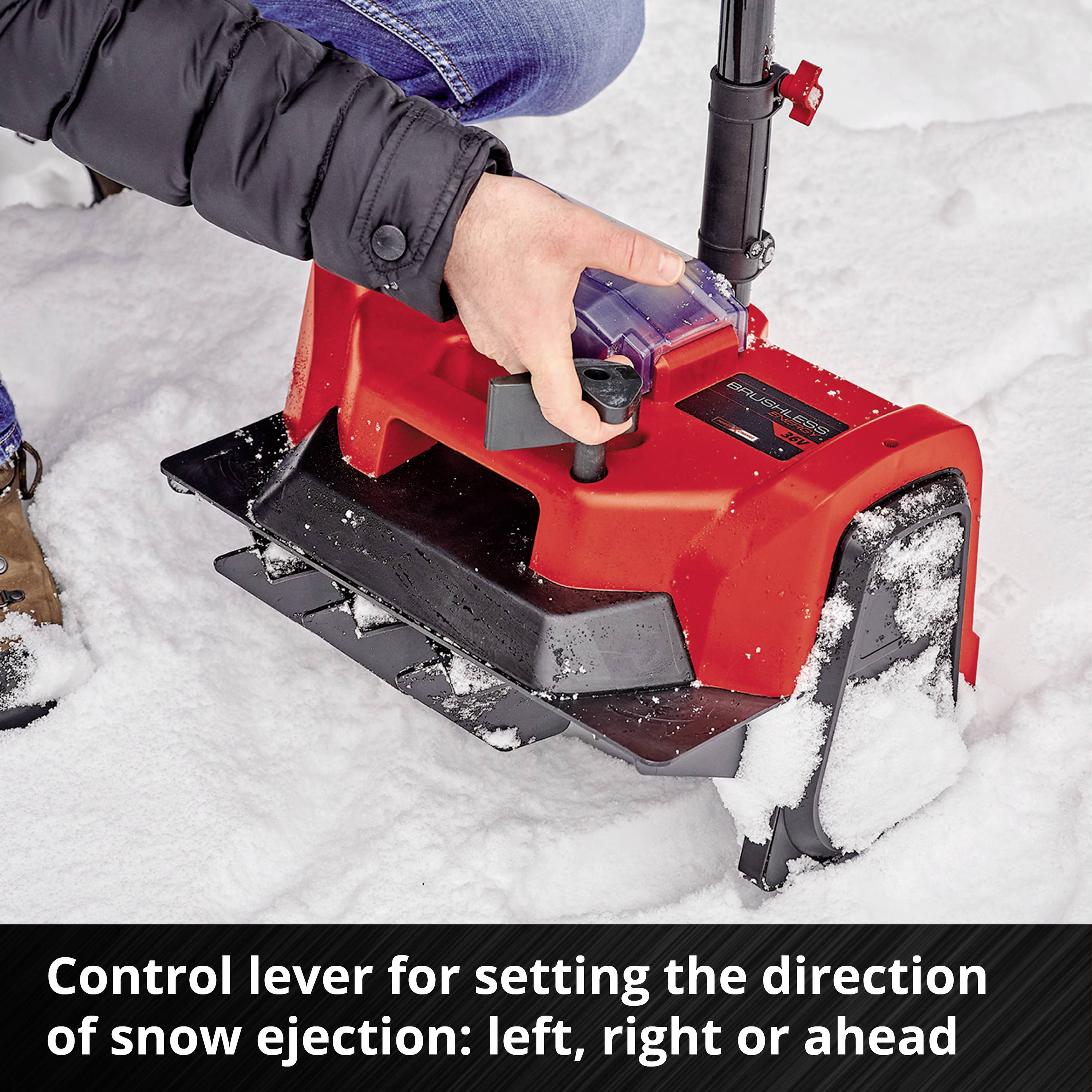A person is operating a snow blower lever to adjust the discharge direction: left, right, or straight ahead. Close-up shot with a gloved hand.