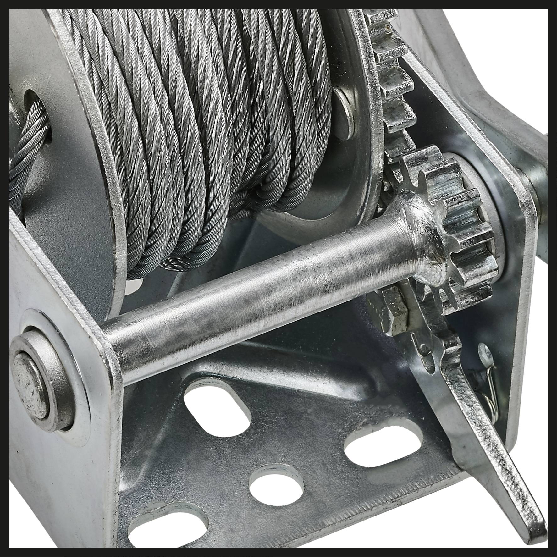 A metal rope winch with a visible gear wheel and cranking handle, used for lifting or pulling heavy loads.