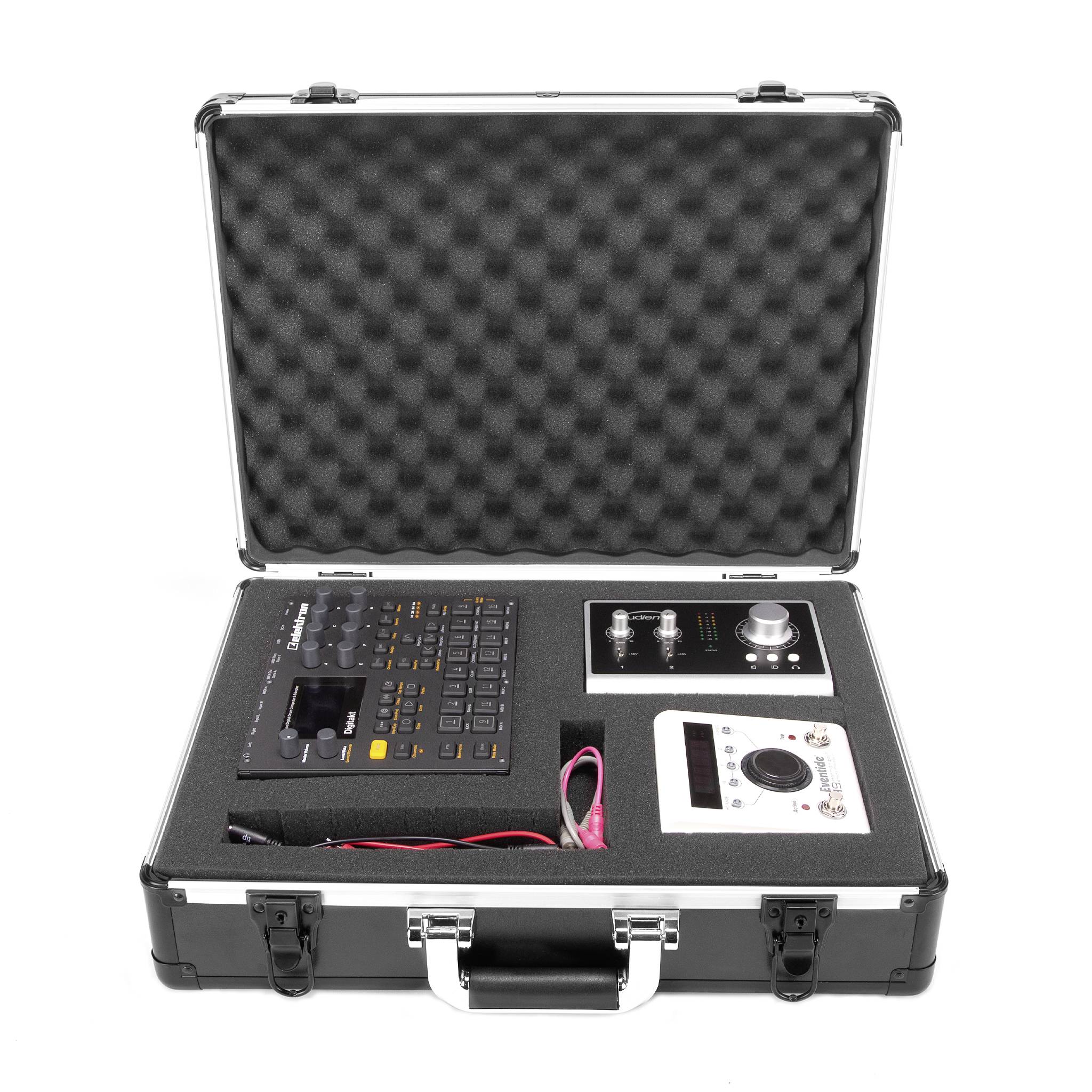 An open suitcase reveals an electronic audio mixing desk and accessories, neatly organised in a padded foam insert.