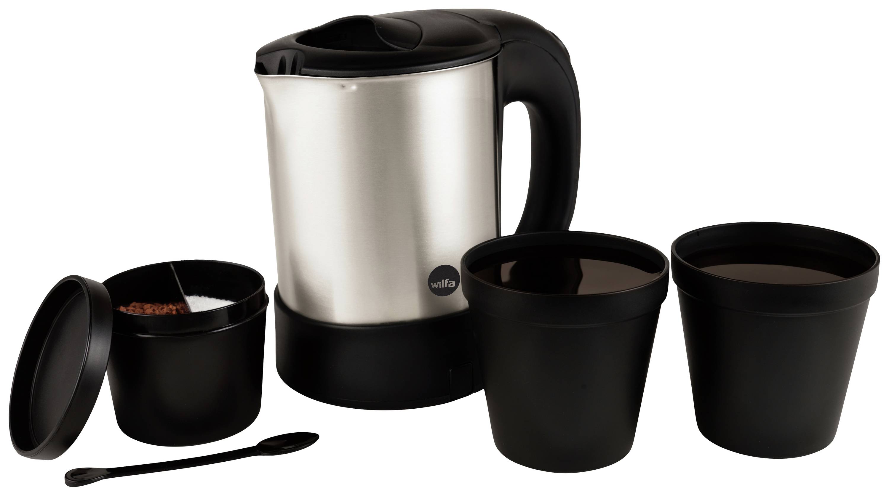 A silver kettle and three black mugs, one of which is open and shows a tea bag. A black spoon lies beside them.