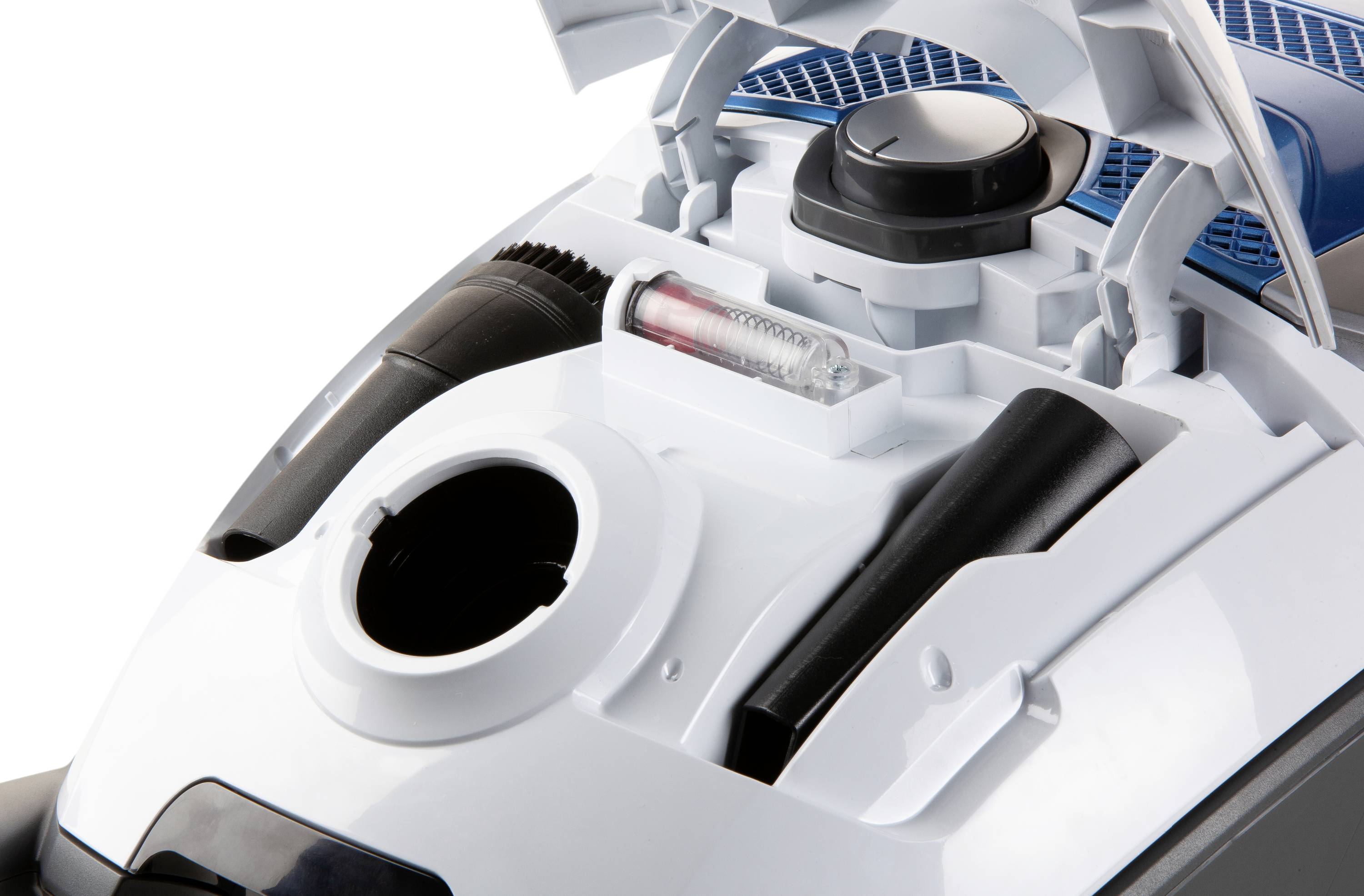 Close-up of an opened vacuum cleaner container, showing the filter and accessories. Suitable for cleaning purposes and filter replacement.