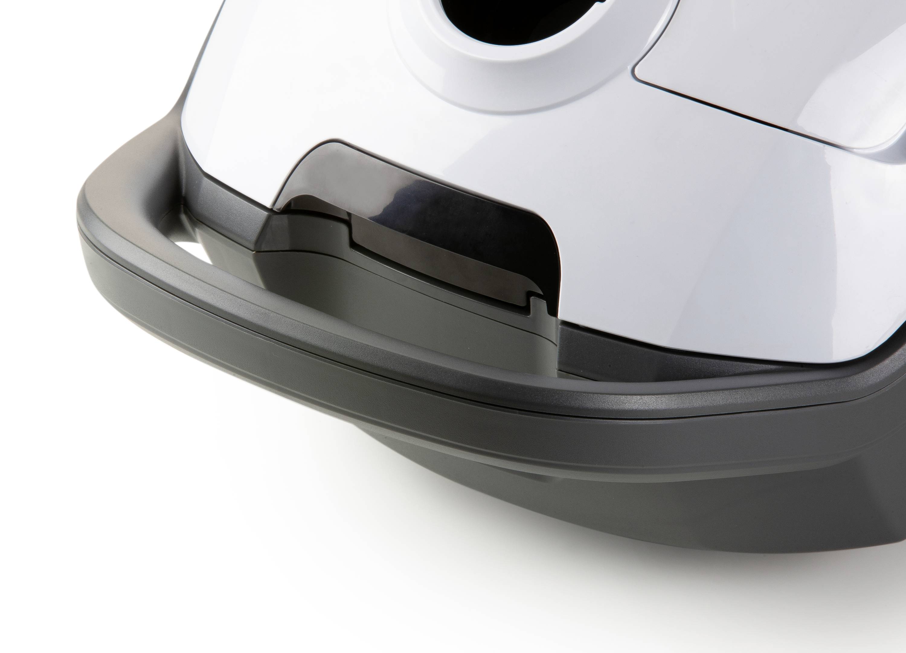 A grey-black vacuum cleaner, close-up of the lower section with casing and handle visible.