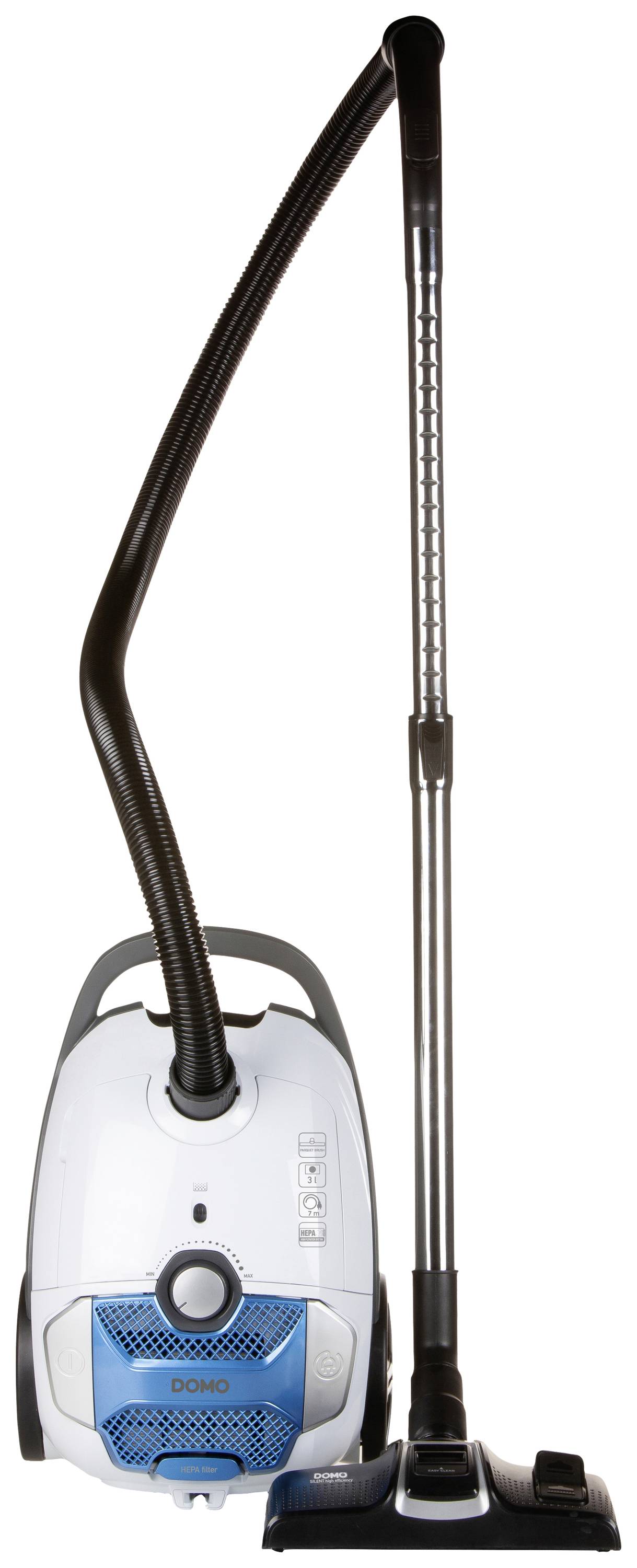 A white upright vacuum cleaner with blue detailing and a black suction tube, standing vertically with an attached hose and brush.