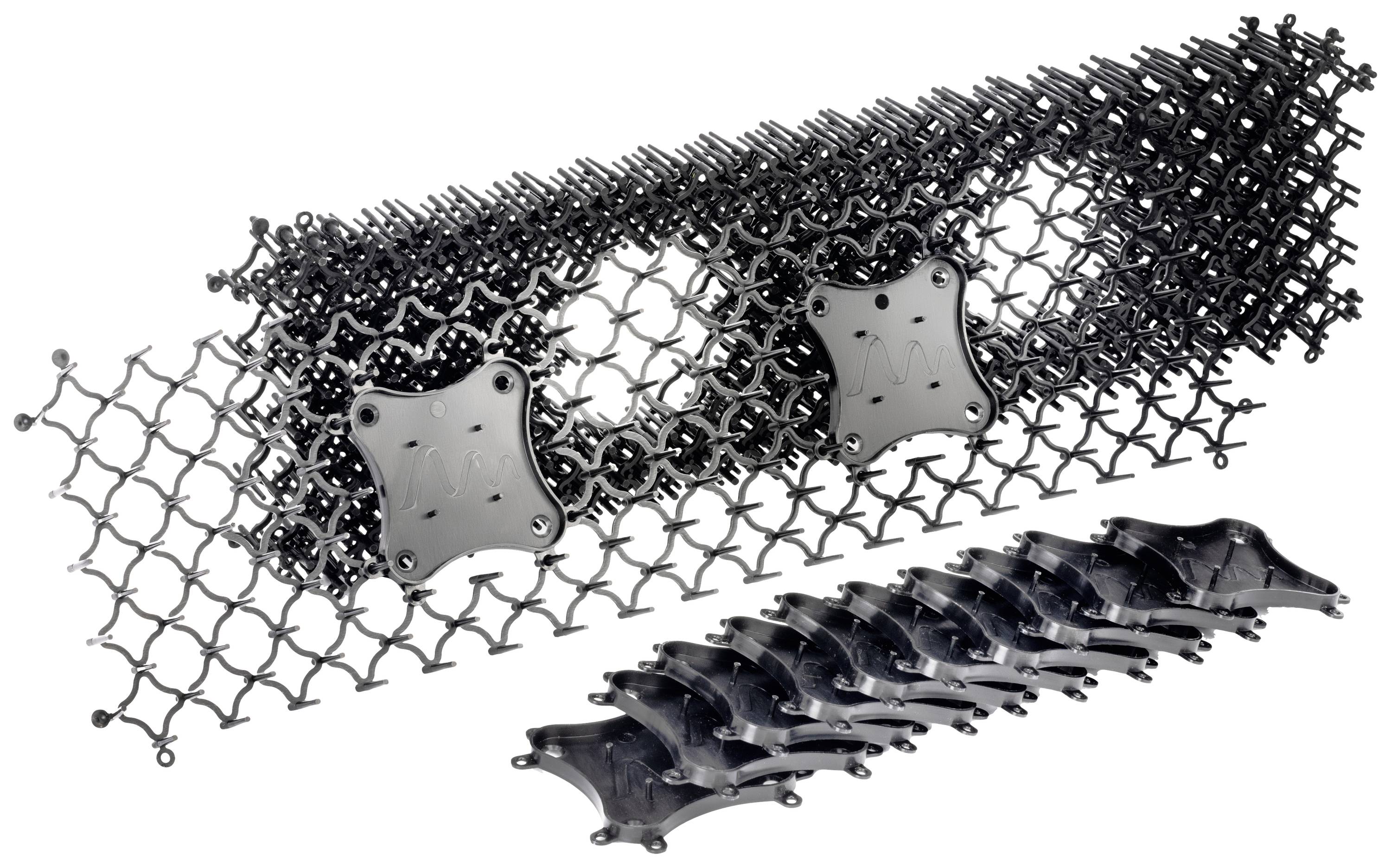 A stack of interlocking plastic grids with square plates in the centre, which can be used for industrial applications.