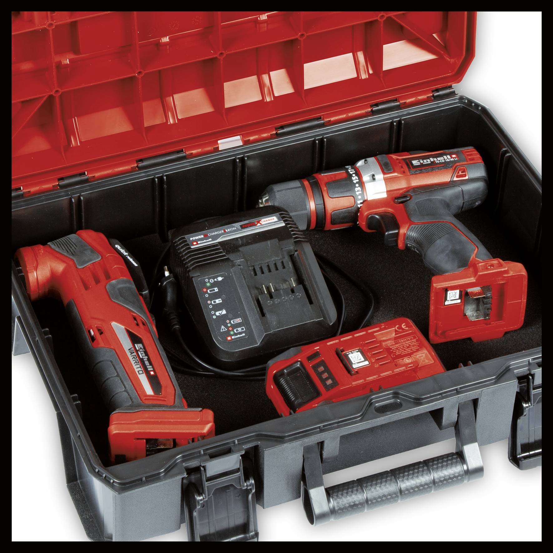 Black tool case with open lid. Two cordless drills, charger and battery in red and black colours.