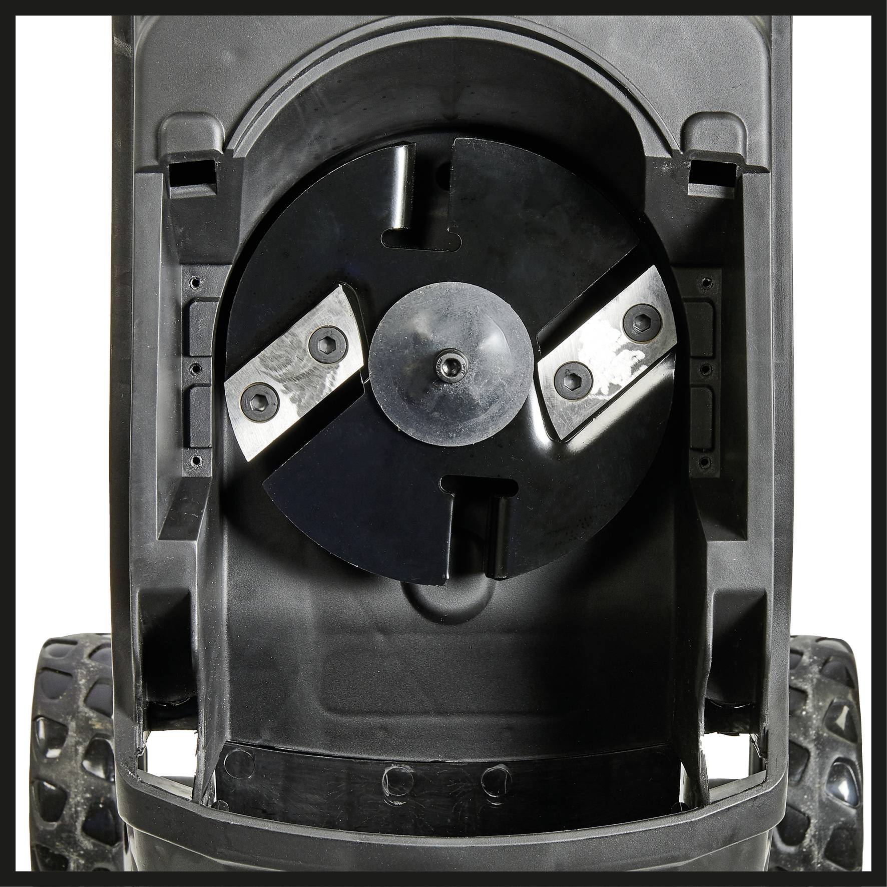 Lawn mower underside with visible rotating blade system and robust wheels used for cutting grass.