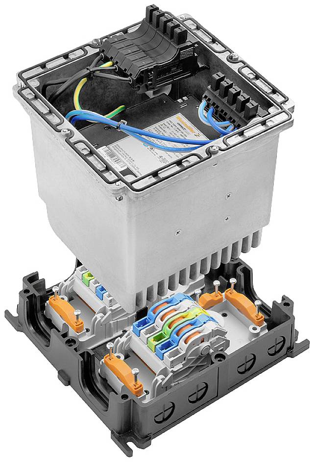 An electrical control unit with an open cover, revealing colourful cable connections and circuits, likely part of a larger system.