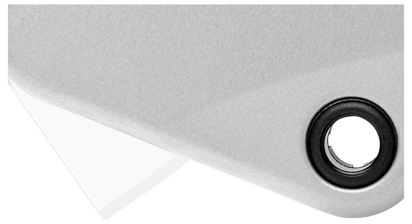 A silver surface with a black round opening and a white triangular element beneath it.