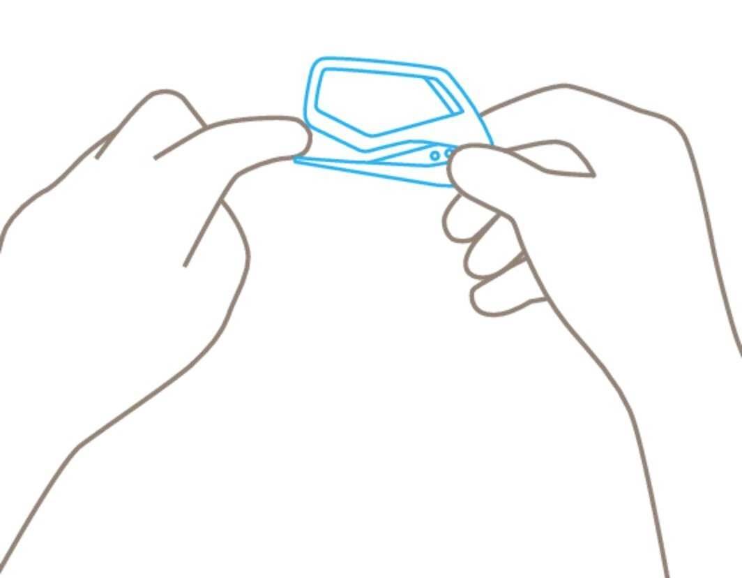 A simple drawing shows two hands holding a small, rectangular object.