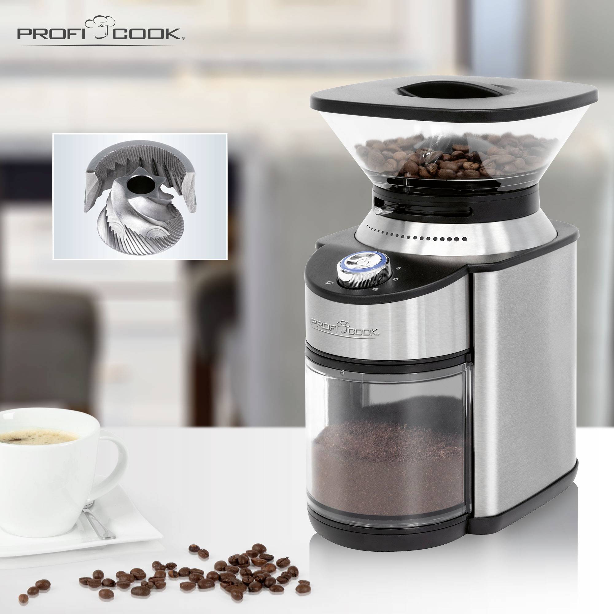 Stainless steel coffee grinder, filled with coffee beans. Beside it sits a cup of coffee on a table.