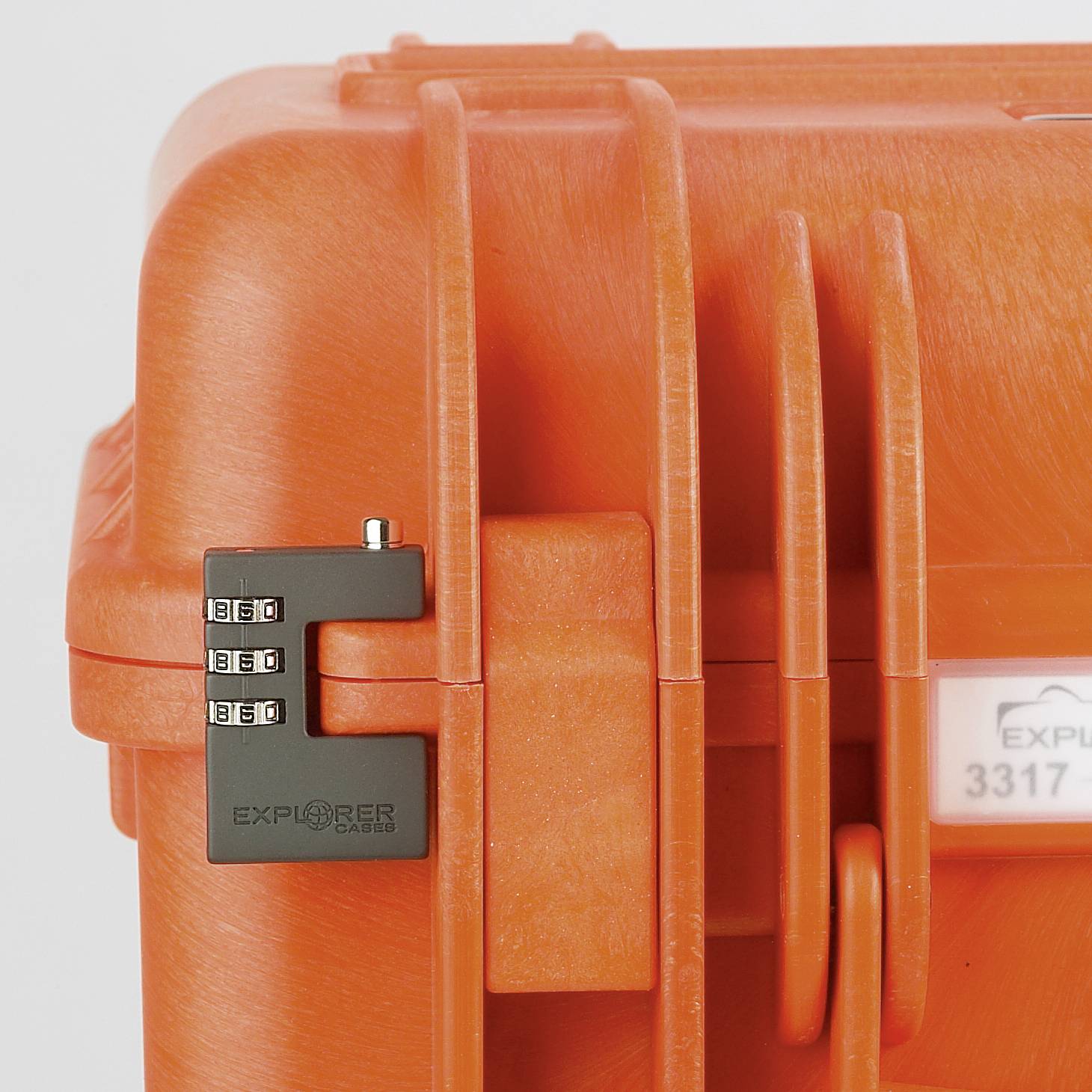 An orange hard-shell suitcase with a black combination lock on the side.