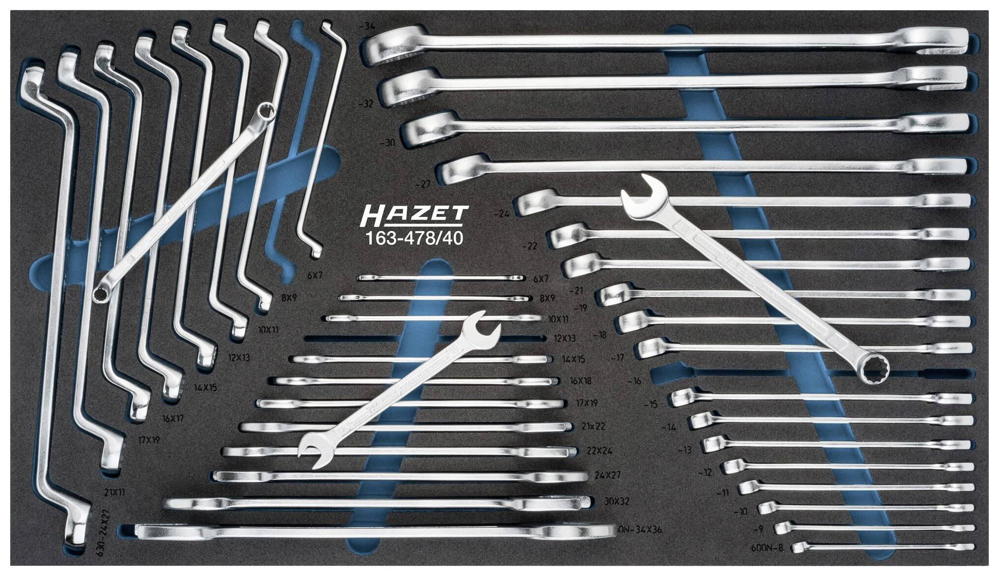 A collection of HAZET spanners in various sizes, neatly arranged on black foam with blue accents.