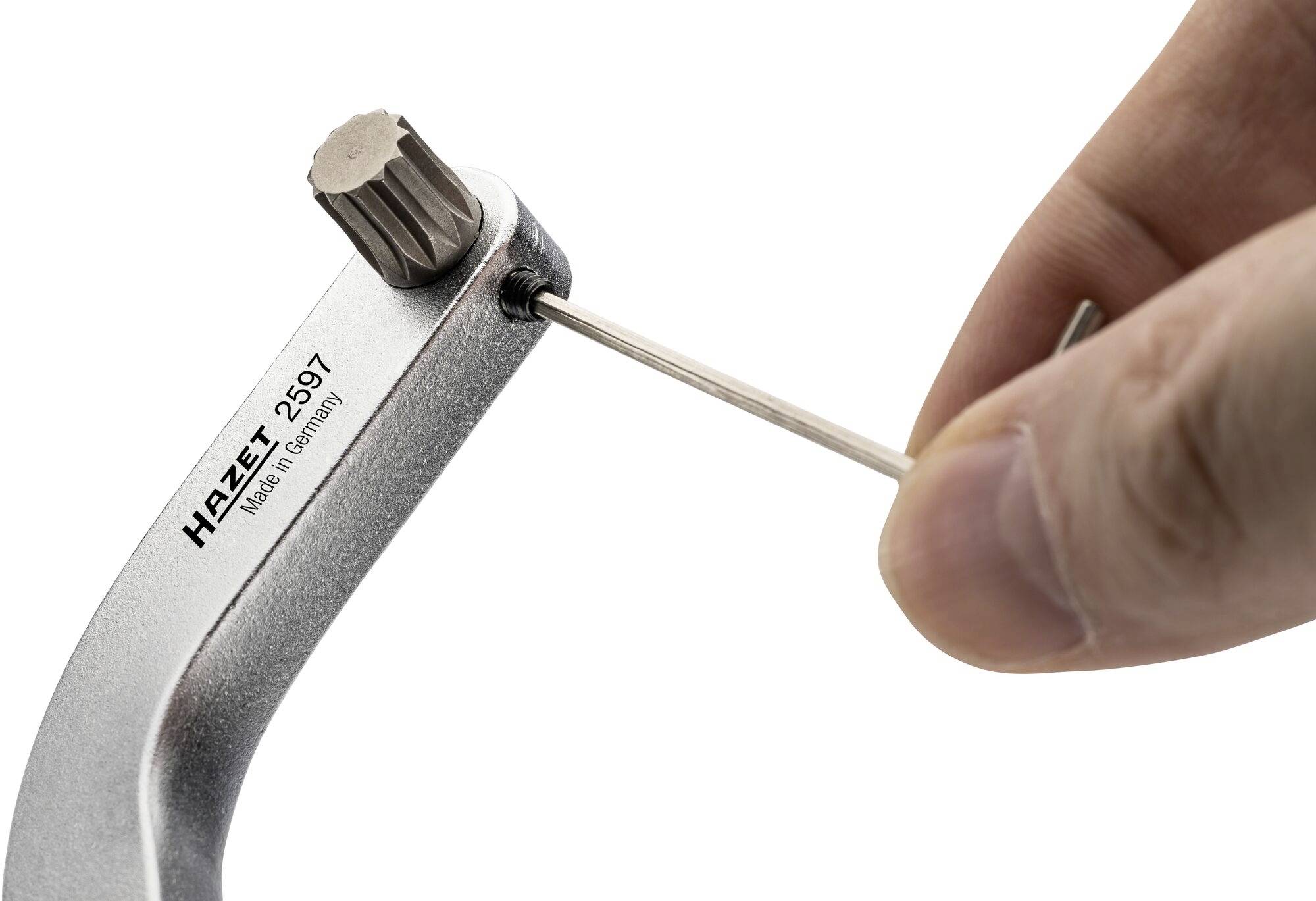 A hand is holding a Hazet torque wrench tool, model 2597, and adjusting a setting with a small pin.