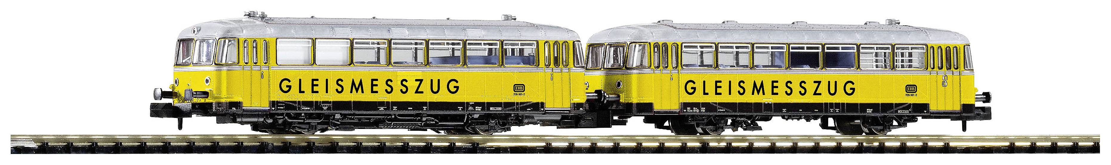 Two yellow track measurement trains on a railway line, with windows and the inscription 'TRACK MEASUREMENT TRAIN', used for measuring railway tracks.