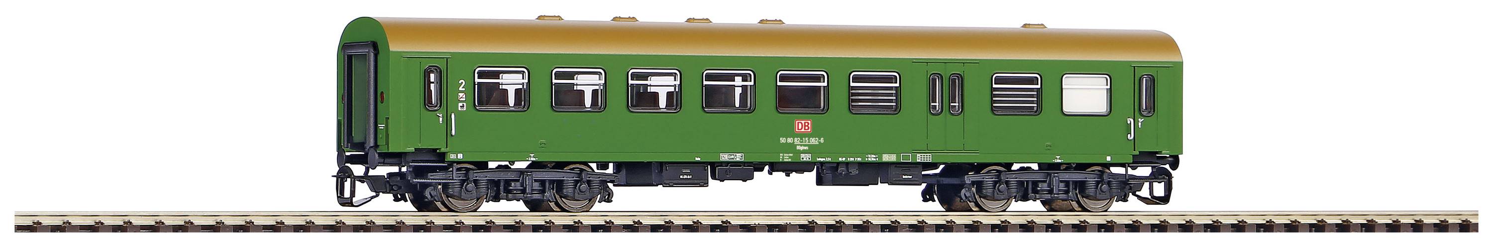 A green railway carriage stands on tracks. The carriage has a golden roof, multiple windows, and belongs to a model railway.