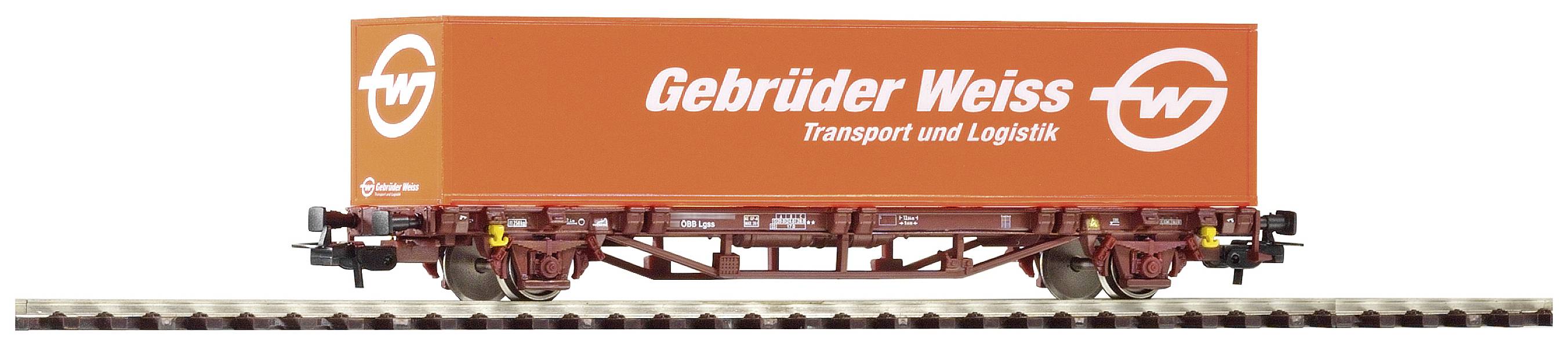 An orange goods wagon with the inscription 'Gebrüder Weiss Transport and Logistics' on a section of railway track.