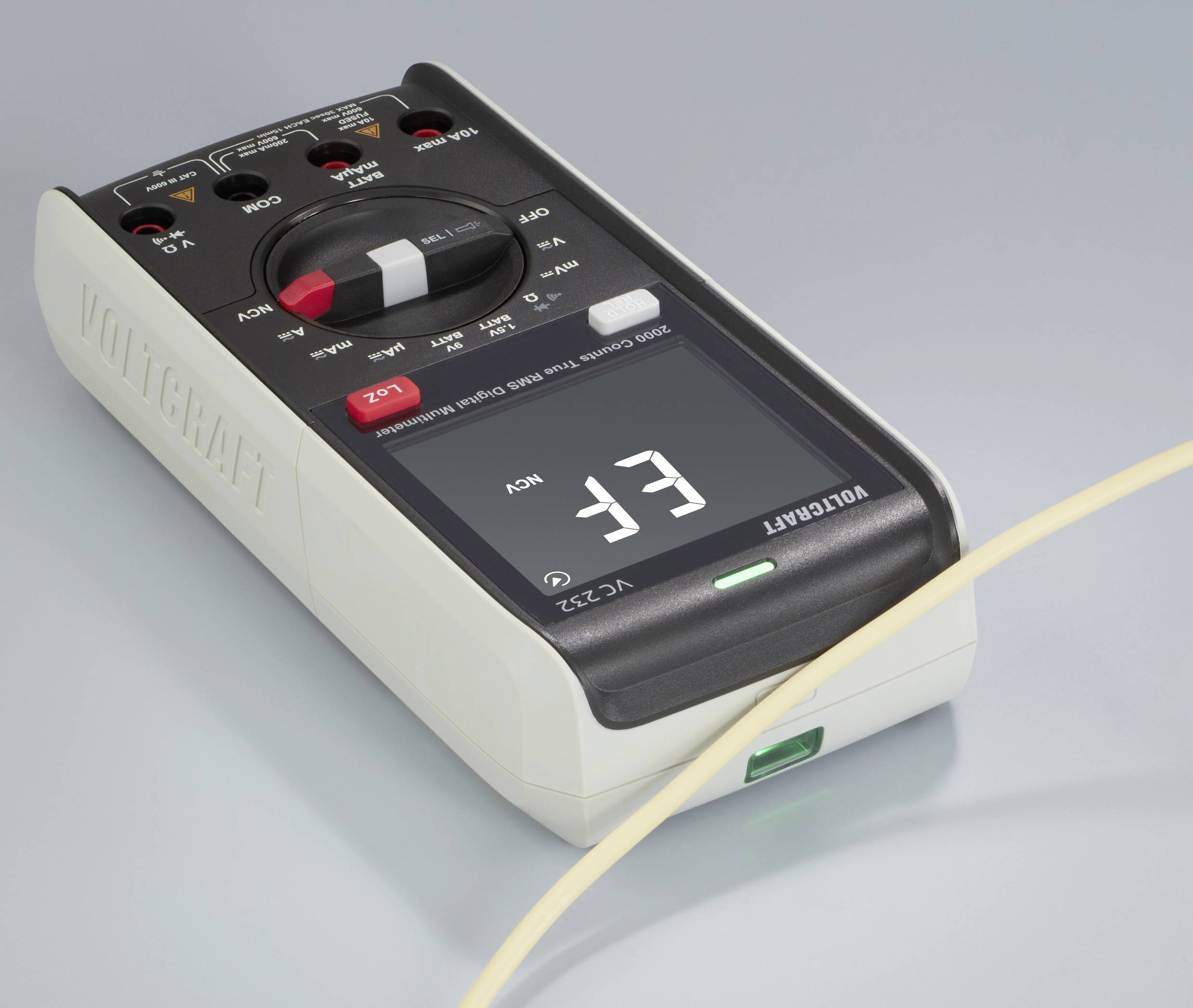 A digital multimeter is displaying 'EF' on its screen. A cable is connected to the device, which is resting on a grey surface.