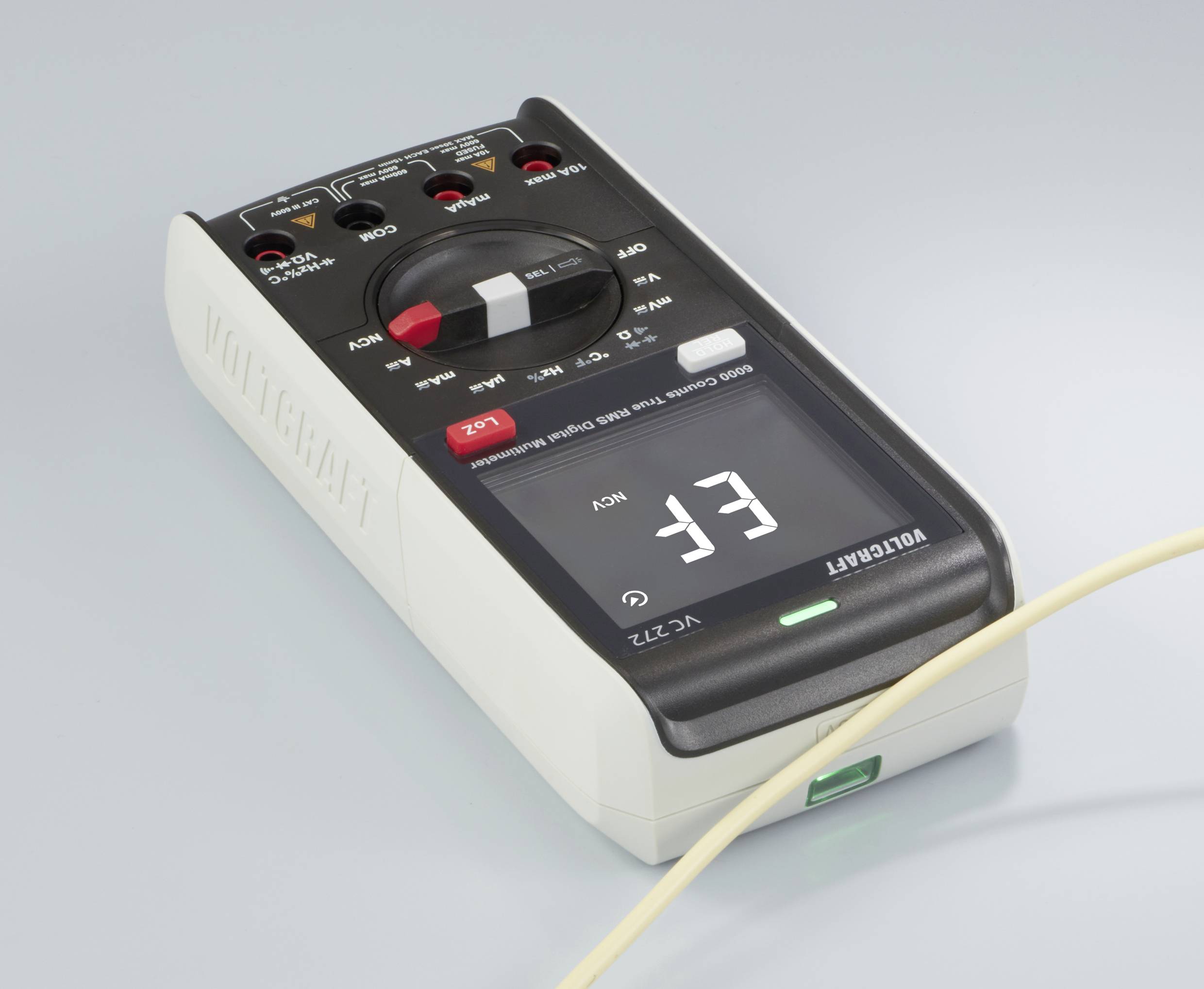 Multimeter in close-up. It shows a reading of 33. A yellow cable is connected.