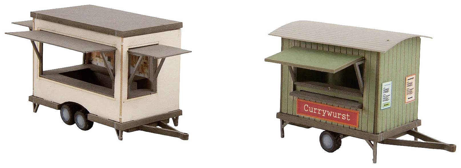 Two model food stalls: on the left a beige trailer with open sales windows, on the right a green stand with the inscription 'Currywurst'.