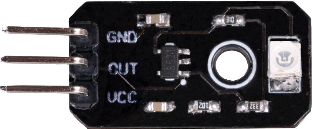A black moisture sensor with three pins labelled as 'GND', 'OUT', 'VCC'. A microchip is positioned in the centre.