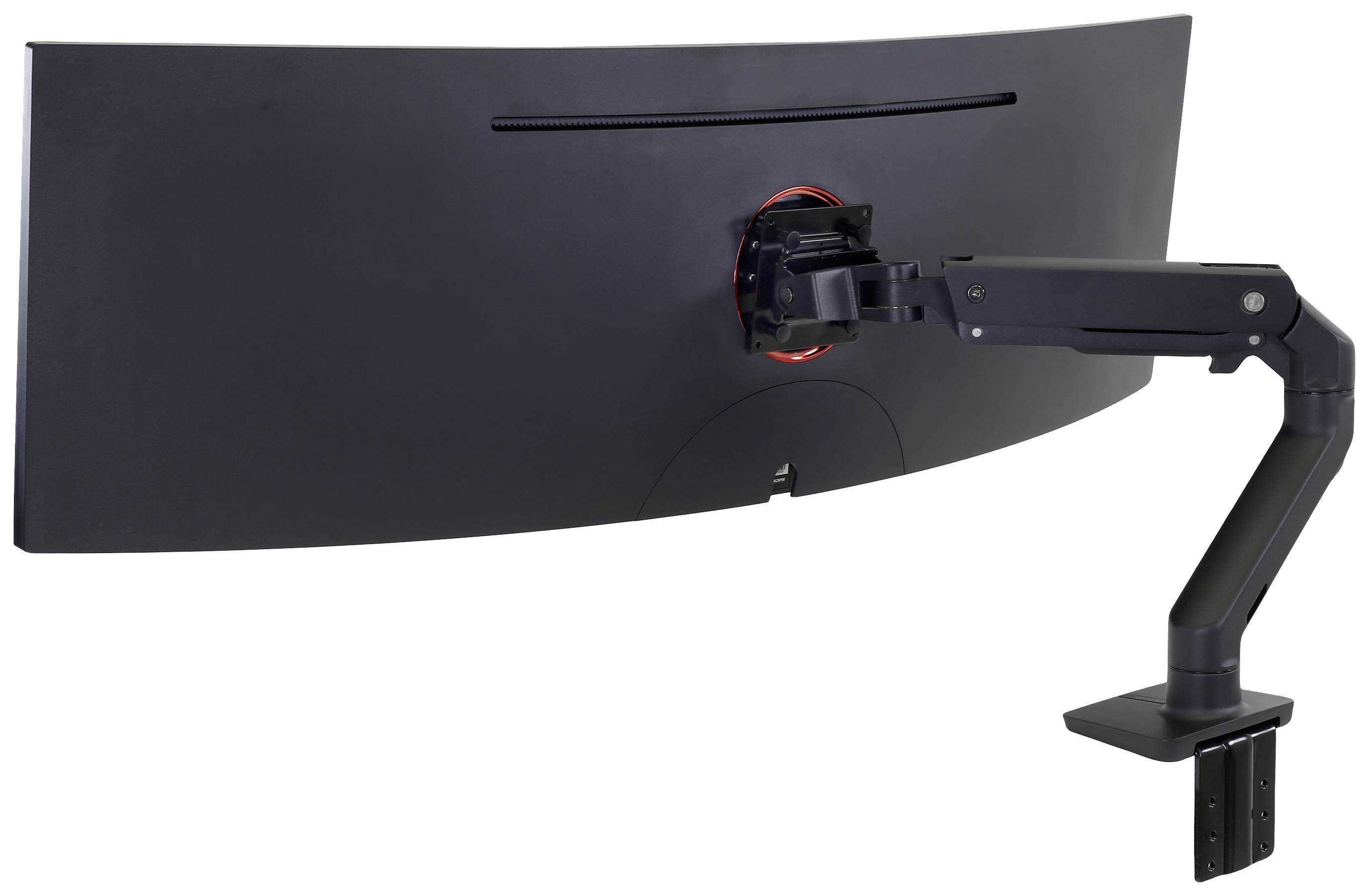A black, curved computer monitor back, mounted on a swivel, adjustable arm attached to a desk.